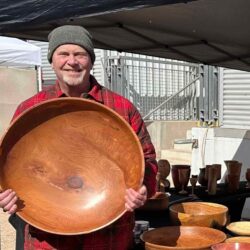 Ron-Martel-holds-one-of-his-bowls-at-a-market