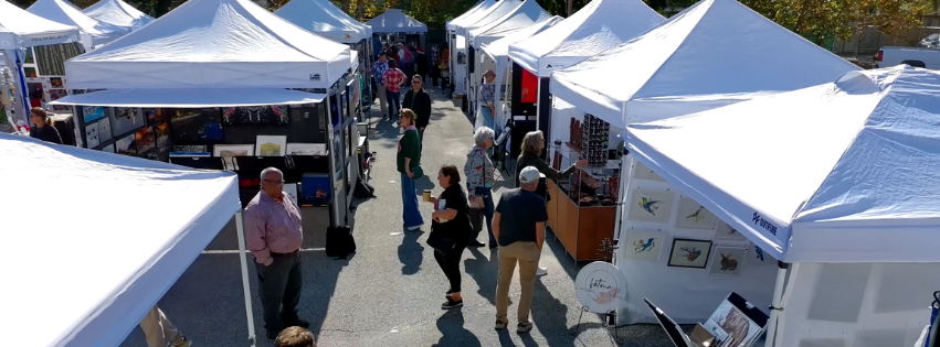 Crowd enjoying First Saturday Arts Market—Houston's original monthly outdoor fine art event in the Heights with dozens of juried artists under white tents.